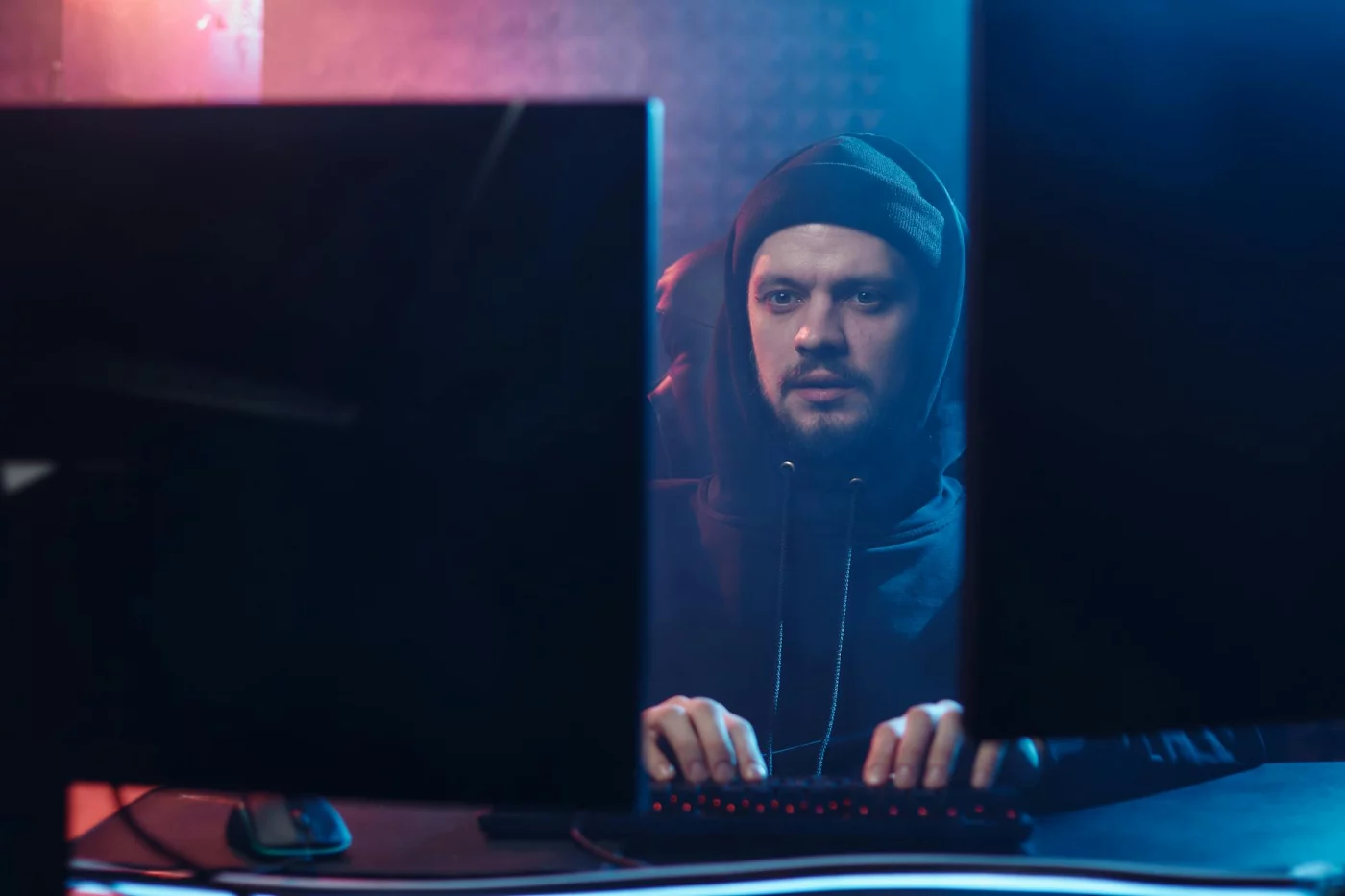Player at a dual-monitor setup reviewing anti-cheat flags during a Marvel Rivals ban appeal