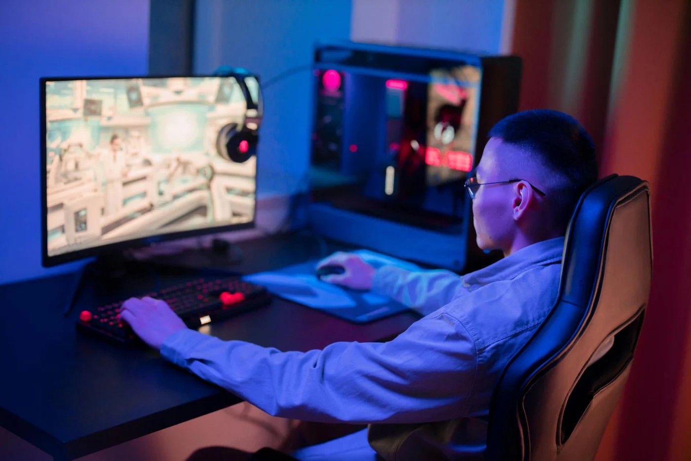 Gamer at a modern PC setup illustrating how RICOCHET anti cheat works in competitive online play